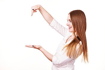 Woman showing presenting, long haired fashionable girl holding empty hand palm copy space for product. Beauty, fashion, advertisement concept. Studio shot on white background