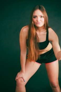 Young woman stretch in sportswear.. Sport exercise and wellbeing. Young woman with healthy lifestyle train in gym wear black sportswear exposed stomach.
