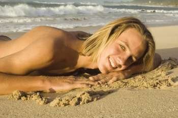 Portrait of a young man lying on the beach