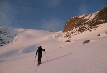 backcountry skier heading to a distant mountain peak in the Swiss Alps
