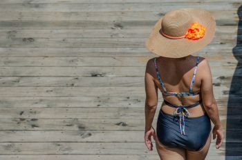 The back of a beautiful Asian woman wearing a sexy swimsuit