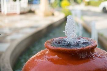 Closeup of water jar fountain