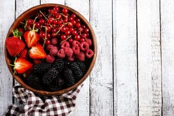berries in bowl on a table, fresh berries