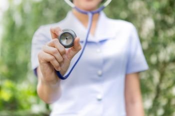 Close-up of nurse using stethoscope , focus on stet