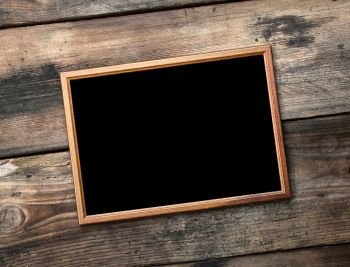 rectangular brown wooden frame on a background of very old boards, empty space