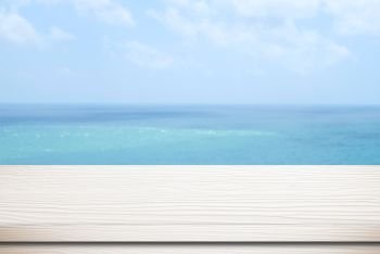 Empty white wood table over blur sea and blue sky background, template, product display montage