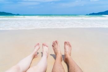 Couple legs sunbathing near the beach during travel holidays vacation outdoors at ocean or nature sea at noon, Phuket, Thailand
