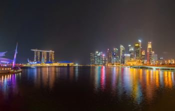 Singapore Downtown skyline at night with reflection. Financial district and business centers in technology smart urban city in Asia. Skyscraper and high-rise buildings.
