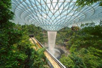 Jewel Changi Airport in Singapore City. Interior design decoration with waterfall, garden and trees. The world’s best airport and destination