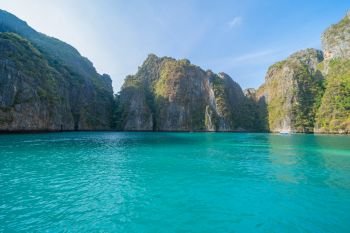 Phi Phi, Maya beach with blue turquoise seawater, Phuket island in summer season during travel holidays vacation trip. Andaman ocean, Thailand. Tourist attraction with blue cloud sky.