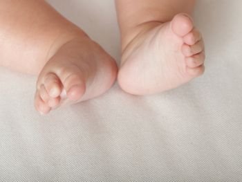 Baby small toe foot on white background