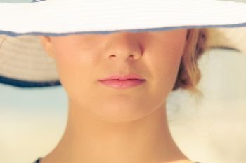 Closeup of woman girl head in striped hat. Summer fashion.. Closeup of fashion woman in striped summer hat.