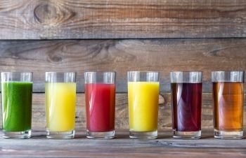 Assortment of fruit juices on the wooden background