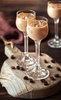Two Glasses Of Irish Cream Liqueur On The Wooden Board