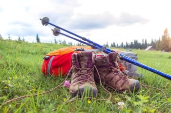 travel. the tourist goes on a hike through the mountains - a backpack, boots and Trekking poles
