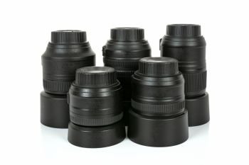 Group of professional and modern lenses for DSLR camera isolated on a white background in close-up