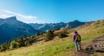 A woman hiker walking in the Pyrenees mountains near the Pic Ossau