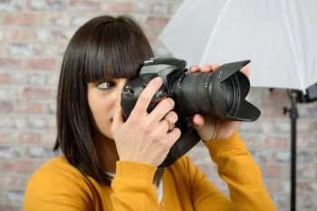 Attractive brunette woman with photo camera
