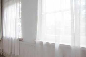 White net curtain against two windows in a house, interior. White net curtain against two windows in a house,
