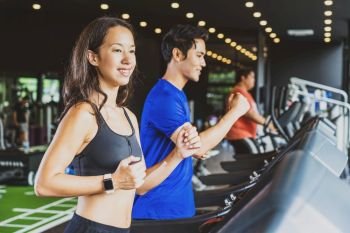 Couple young diversity working out in gym fitness sport complex, workout working out running and cardio, posture position, sports and healthcare concept