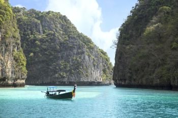Maya Bay in Andaman sea and wooden boat with mountain view in phuket Thailand