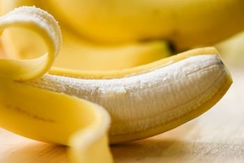 Banana peel / Close up od fresh ripe a banana fruit peeled on wooden board 