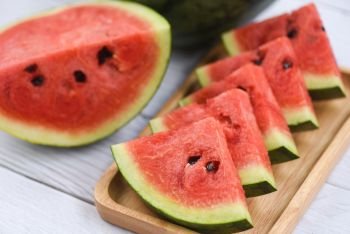 Fresh watermelon slices on wooden background