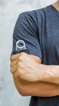 Man use handgrips for exercise.