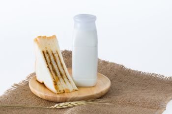 Bottle milk with sandwiches on white background.