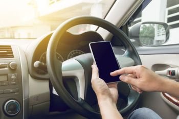 man driving car and using mobile phone