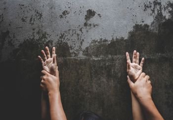 Close up of man hands holding a woman hands for rape and sexual abuse concept.