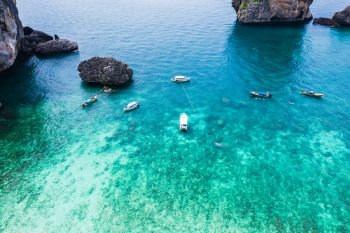 phi phi island high season and driving tourist boats beautiful crystal clear water emerald green and dark blue kra bi Thailand aerial view