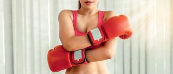 Boxer woman does boxing sport in fitness gym. Healthy lifestyle.