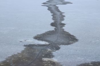 crack on the surface of the ice on the river