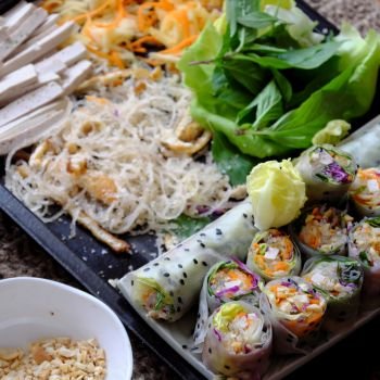 Close up sliced vegan rice paper rolls and Vietnamese spring roll ingredient, colorful vegetables make vegetarian dish that healthy and delicious
