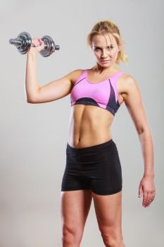 Strong woman lifting dumbbells weights. Fit girl exercising gaining building muscles. Fitness and bodybuilding.. Fit woman lifting dumbbells weights