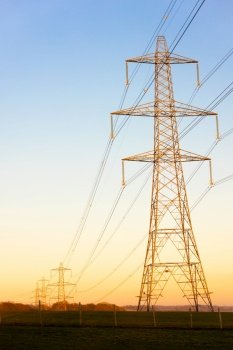 Electricity Pylons of the National Grid at Sunset or Sunrise
