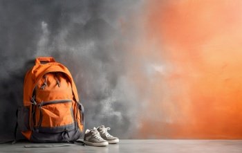 Orange backpack against grunge background. Created with generative Ai technology.
