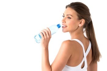 Young beautiful fit woman drinking water after exercise. Woman with bottle of water