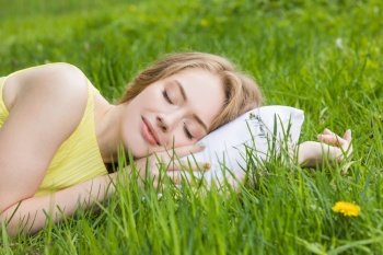 Rest and relaxation concept . Woman sleeping on pillow on grass background of nature. Rest and relaxation concept