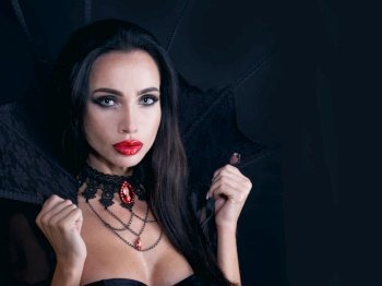 Vampire Halloween woman portrait. Beautiful sexy model girl in Halloween costume and make up. Vampire Halloween woman portrait