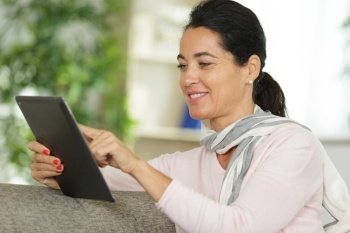 woman reads on tablet computer