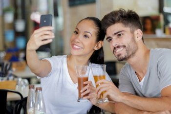 romantic couple taking a selfie in a bar