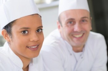 closeup portrait of apprentice chef and her supervisor