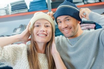 Couple in shop trying on beeny hats