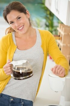woman holding a jug of filter coffee