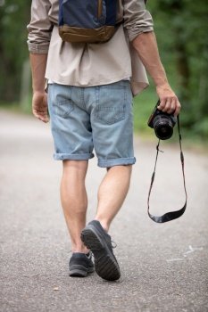 portrait of photographer walking in the forest