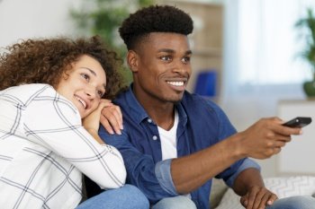 couple watching tv man using remote control