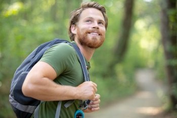 attractive hiker with big traveling rucksack moving up