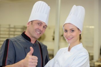 a master chefs giving thumbs up with colleague